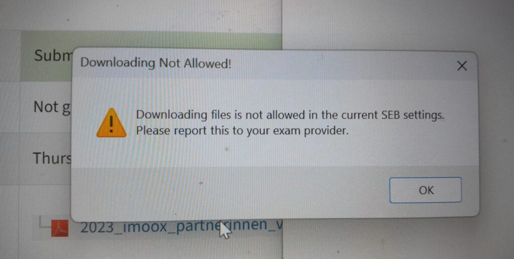 This is a pop up window saying that students are not allowed to open and download files within Safe Exam Browser. The pop up window has a yellow triangular icon with an exclamation mark in it.